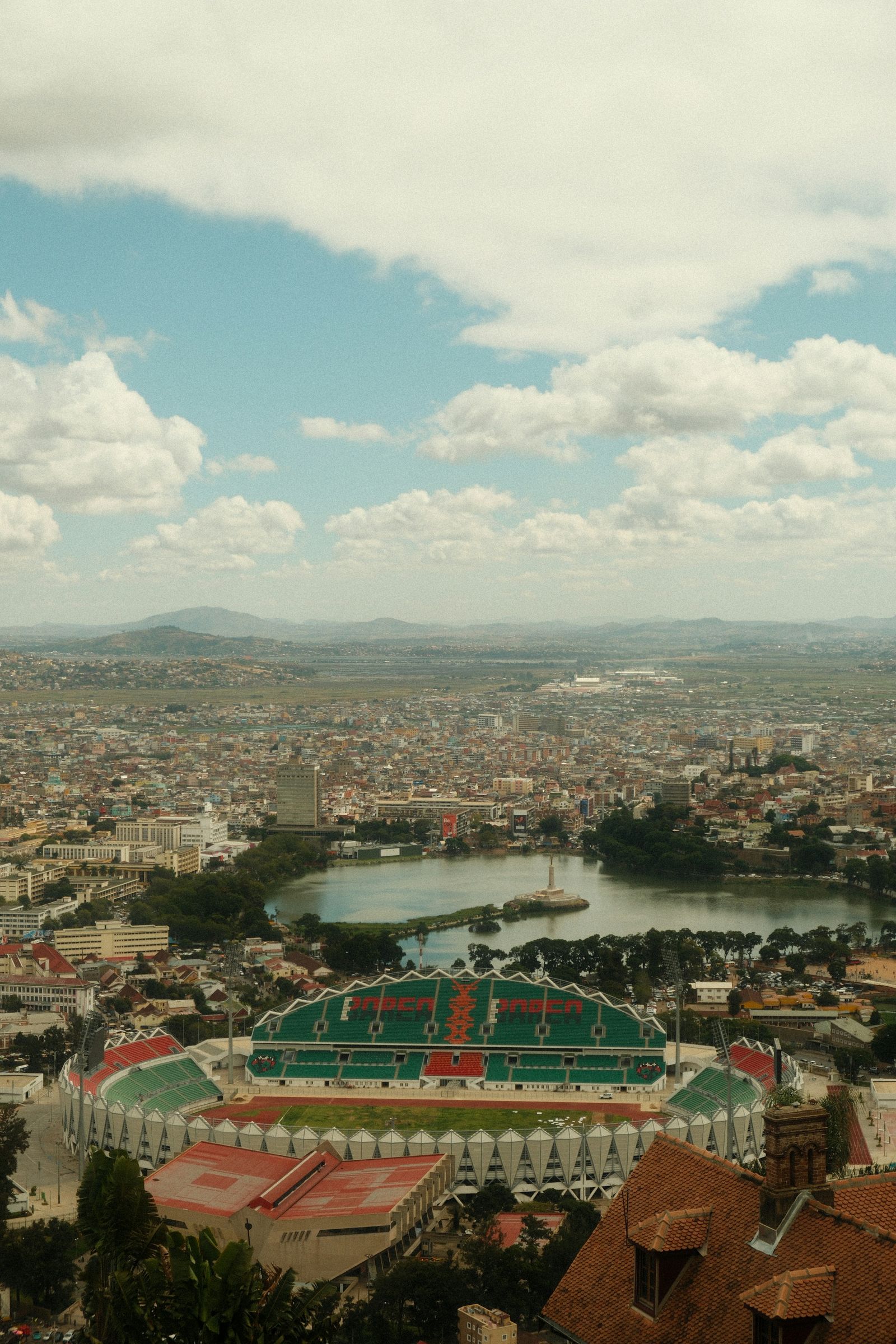 Antananarivo from above: Mahamasina stadium, Lake Anosy with its monument, and the city running out to the hills