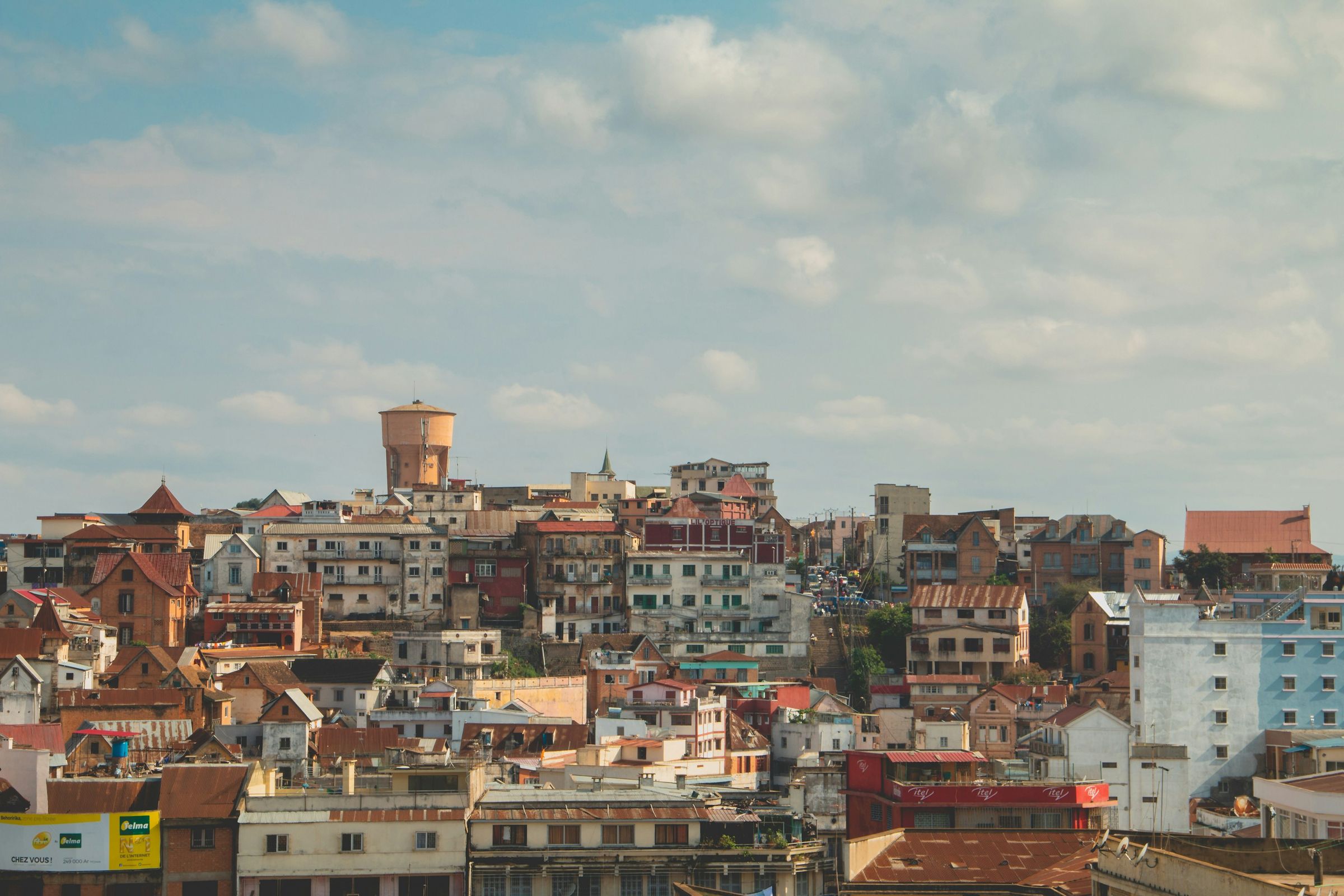 Houses stacked up a hillside in Antananarivo, with a round tower at the top