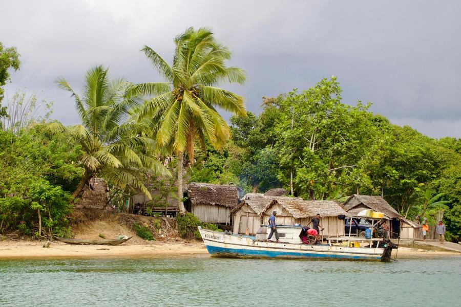 Boats and wooden houses on the shore at Manompana, on Madagascar's east coast