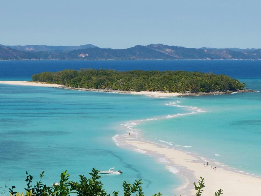 Turquoise lagoon and white sandbar beside a forested island near Nosy Be, northwest Madagascar